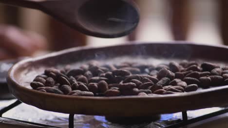 witness the transformation of raw cacao beans as they sizzle and release their rich aroma during the cooking process