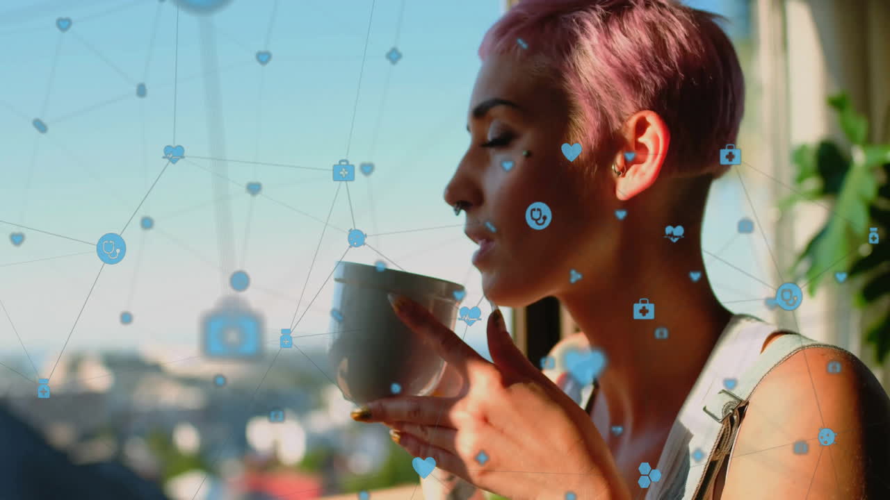 Animation of icons connected with lines, biracial woman enjoying coffee while looking through window