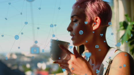 animación de iconos conectados con líneas, mujer biracial disfrutando de café mientras mira por la ventana