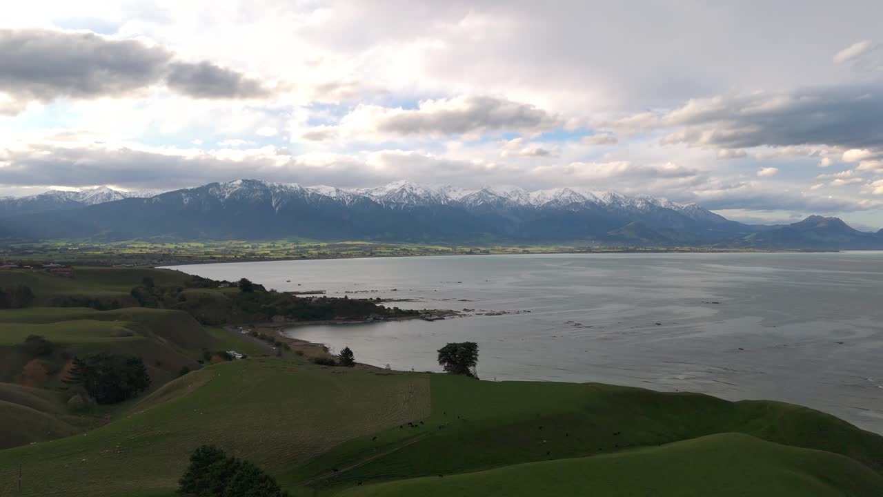Stunning wide-angle view where Kaikoura Ranges of Southern Alps meet the ocean shore