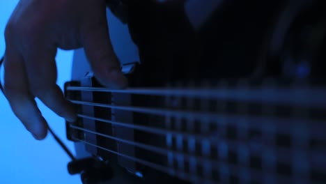 male hands playing the guitar in the studio – slow motion