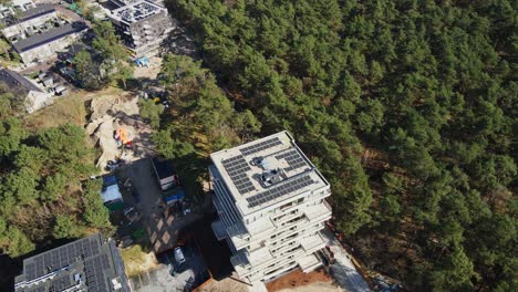 Beautiful-aerial-of-photovoltaic-solar-panels-on-top-of-a-newly-built-apartment-building-on-sunny-day