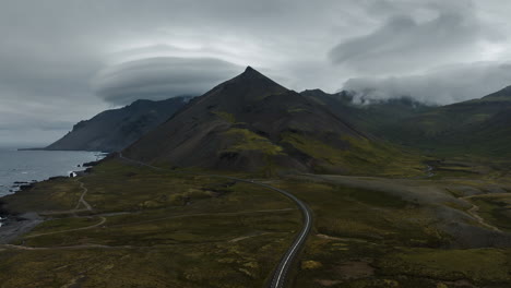 icelandic mountain road under dramatic cloudscape