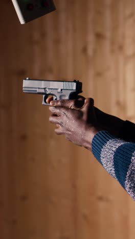 Vertical video Employee loading firearms for shooting range company customers