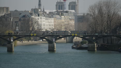 slow left panning bridge ponts des arts with the skyline of paris, france