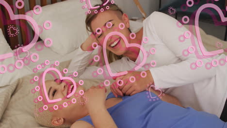 animation of hearts over diverse female couple embracing