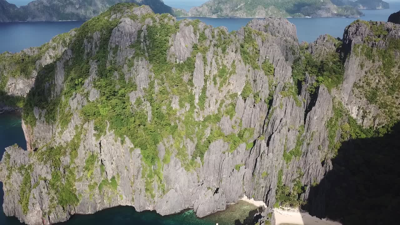 Drone Aerial View of Steep Cliff Above Hidden Beach and Tropical Sea, El Nido, Palawan Island, Philippines