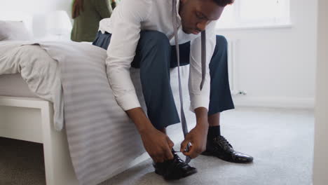 Business-Couple-In-Bedroom-Getting-Ready-For-Work-Businesswoman-At-Home-Putting-On-Shoes