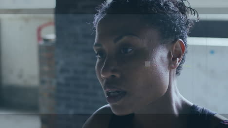 animation of interference over african american sportswoman at gym