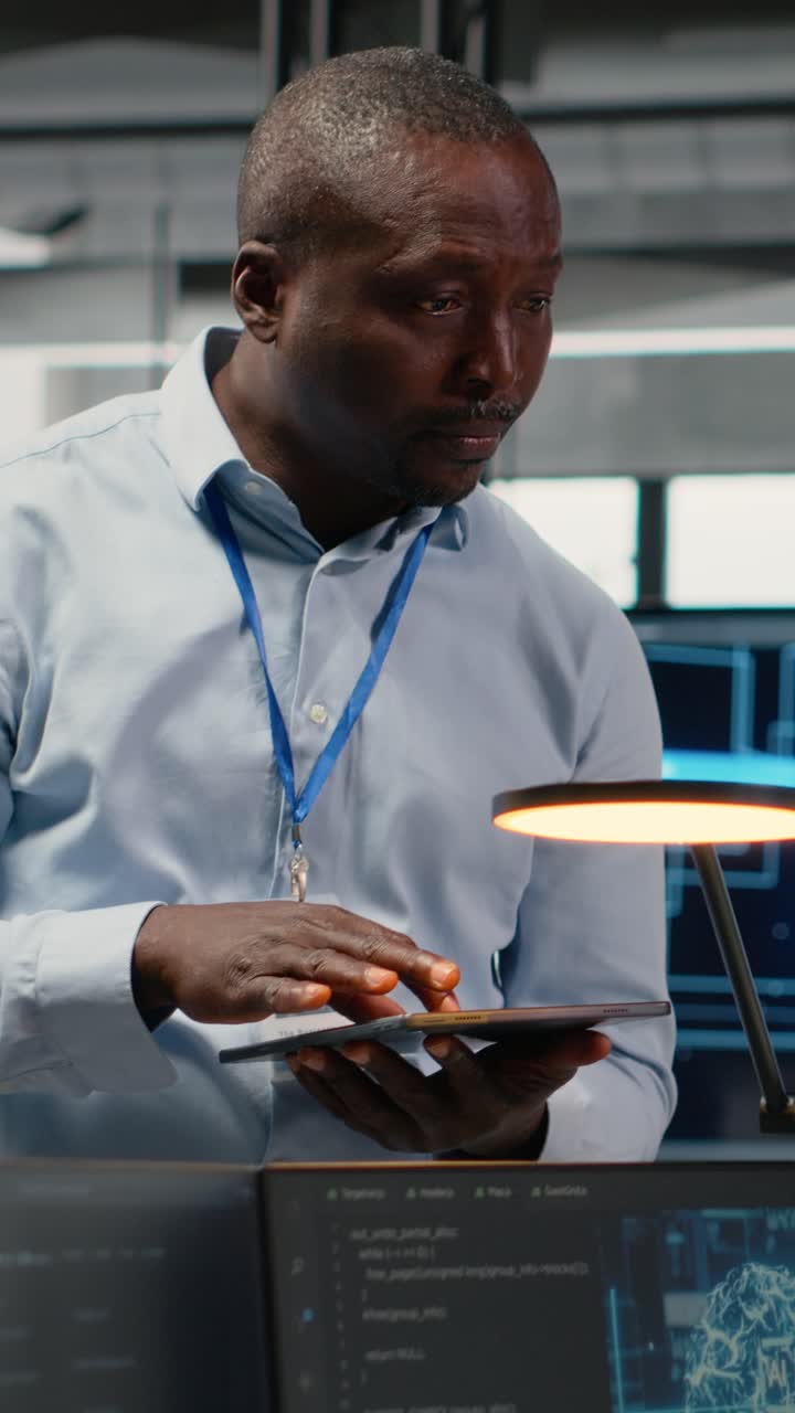 Vertical video Manager talking with intern in office, using AI specialized hardware