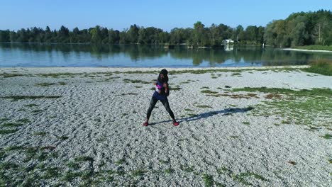 Drone-shot-of-young-attractive-black-female-doing-sports-outdoors