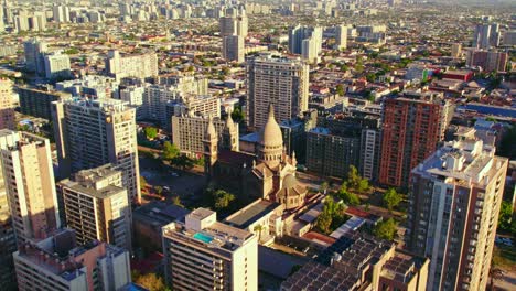 drone shot approaching the los sacramentinos church in sunny santiago de chile