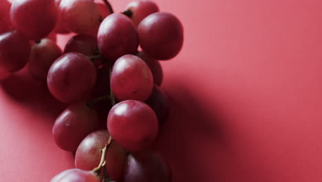 video de uvas rojas con espacio de copia en fondo rojo