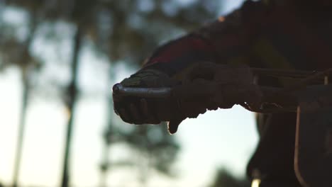 close-up of motocross biker hand in glove turning throttle handle, slow motion