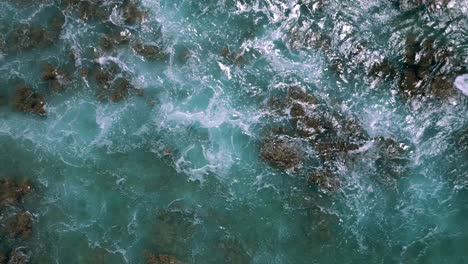 Top-View-Of-Ocean-Waves-Splashing-On-Rocky-Outcrops-In-Hawaii