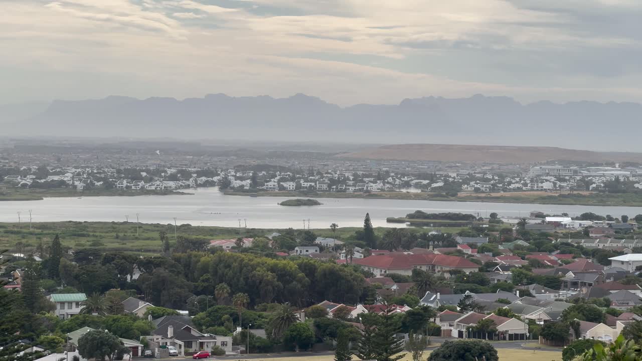 A lagoon in the midday sun. View of Sandvlei and Marina Da Gama in Cape Town, South Africa