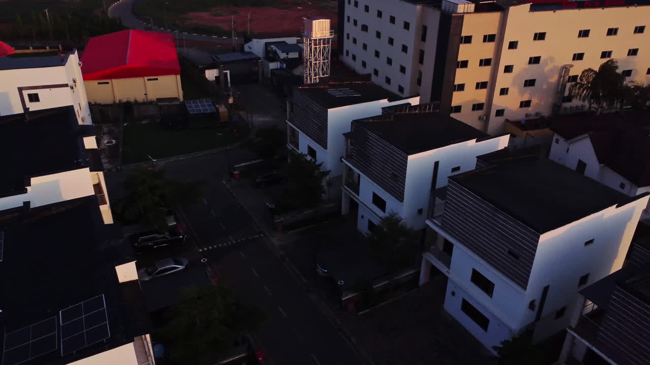 High angle pan of newly built houses in Gudu area near Apo bridge in the city of Abuja, Nigeria on a sunny day. Drone showcase mini white estate housing