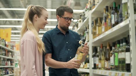 couple shopping for wine in a grocery store