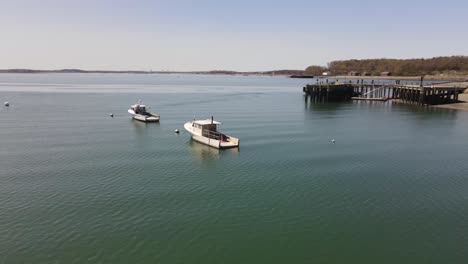 drone circle pan of a lobster boat in hull bay near hull gut