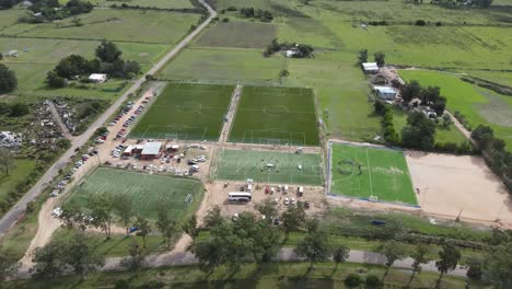 multiple soccer fields host amateur matches in a rural area, providing a hub for sports and community