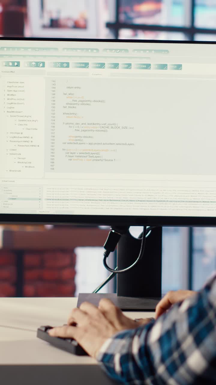 Vertical video Man in home office looking at green screen tablet and computer, typing code