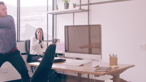 a-young-businessman-destroying-a-computer