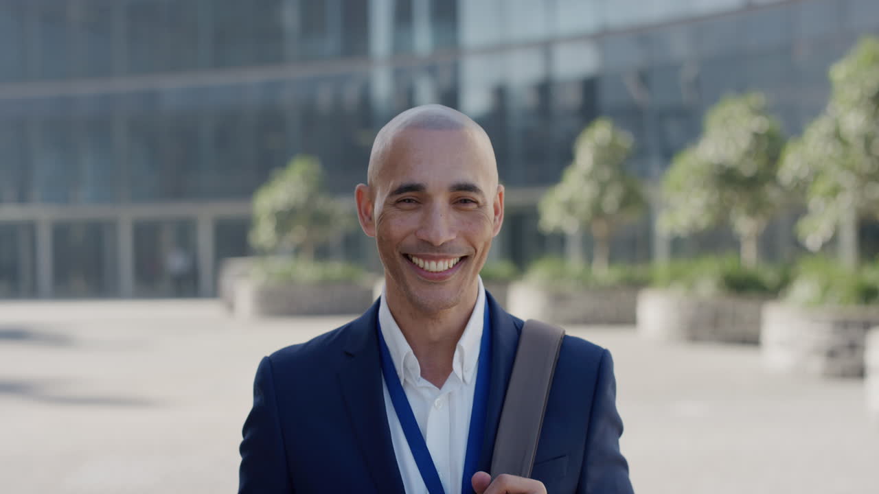 portrait young hispanic businessman smiling executive enjoying professional career success happy entrepreneur commuter in city slow motion