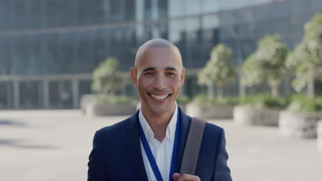 portrait young hispanic businessman smiling executive enjoying professional career success happy entrepreneur commuter in city slow motion