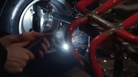 repairing front of beach buggy with welding metal back together in garage