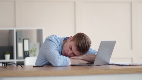 tired employee sleeping at desk