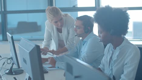 Female-manager-with-tablet-explaining-task-to-male-employee