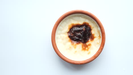 rice caramel pudding in a glass jar on table