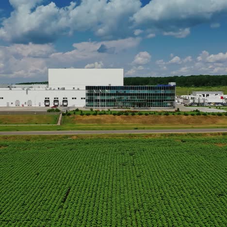 modern plant under blue sky. industrial farm. exterior of the factory among green nature. new modern hangars. aerial view.