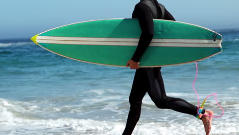 man in wet suit running