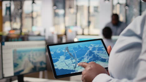 Close Up Of Technician Using Tablet To Work On Futuristic Wind Turbine