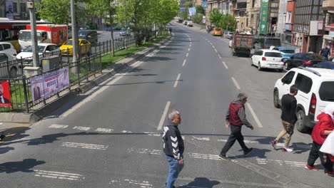 city street scene with pedestrians and cars