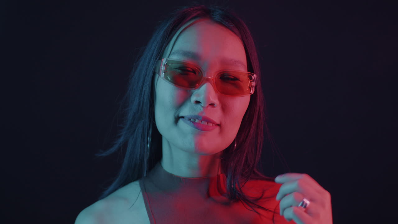 Woman in neon lights with sunglasses