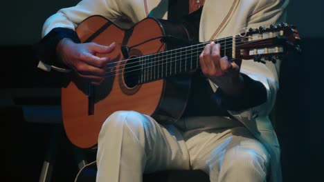 Flamenco-guitarist-in-white-suit-plays-flamenco-music-chords