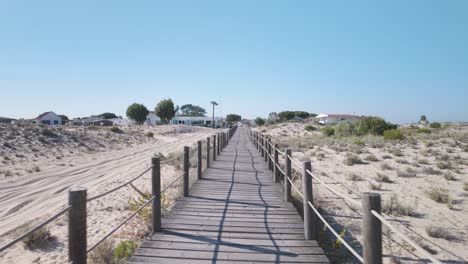 long beach walkway on ilha da armona in olhão portugal crossing dry coastal dunes