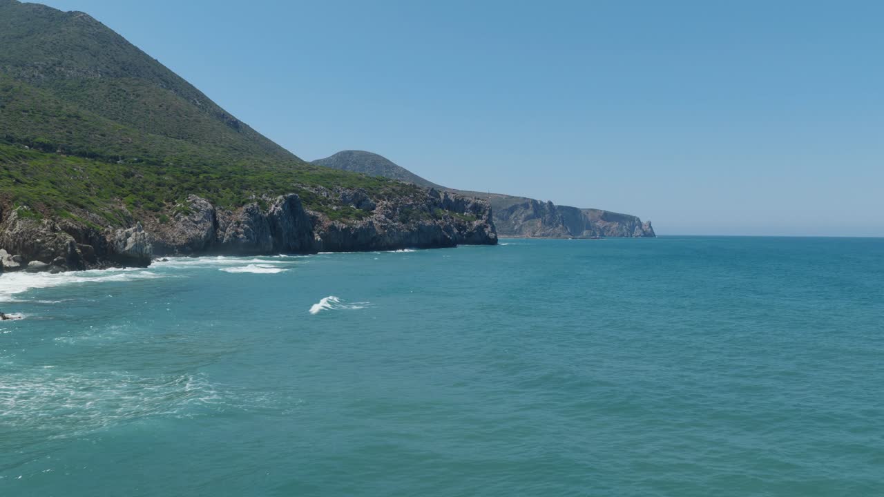 Stunning Sardinian coast with cliffs, blue sea, and distant hills
