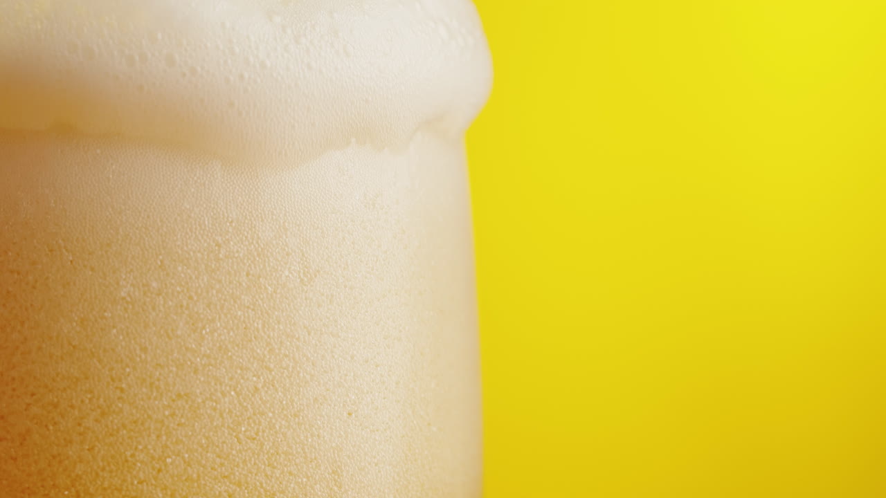 Close-up of a glass of beer with froth