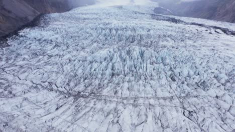 massive white ice glacier on slope of mountain in vatnajökull national park, iceland