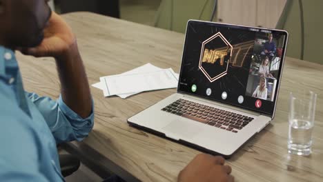 african american businessman using laptop for video call with diverse business colleagues