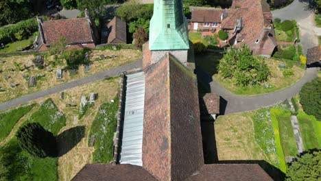 reveal shot of the green spire of the village church in barham in kent, uk