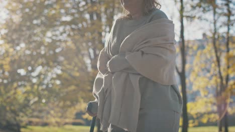 senior woman with walking stick at the park