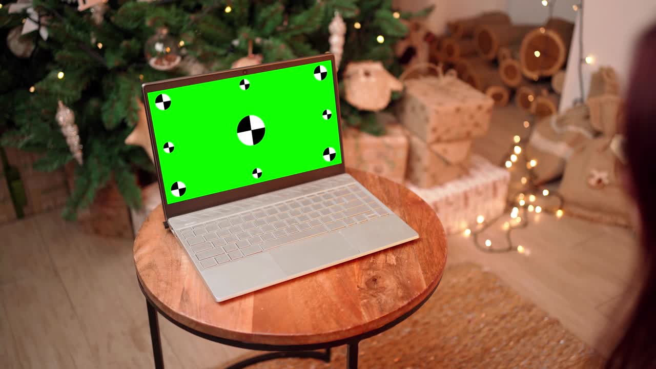 la mujer de navidad se comunica por video llamada usando una computadora portátil con pantalla verde.