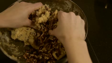 kneading chocolate into dough with bare hands