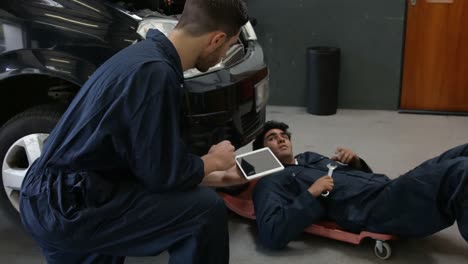 handsome mechanics repairing a car