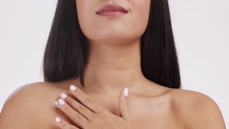 woman applying lotion to her chest