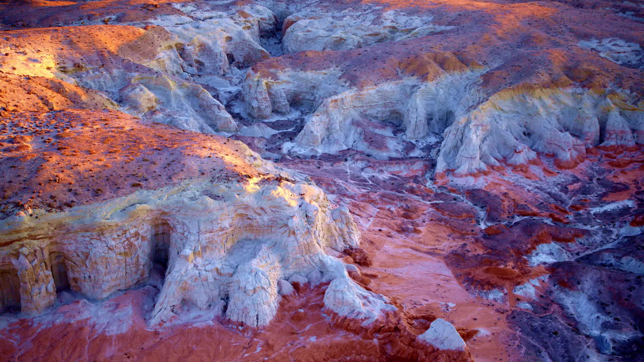 A slow, sweeping aerial shot captures the mesmerizing hues and towering hoodoos near the Utah-Arizona border.